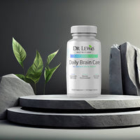 Lifestyle image of Dr. Lewis Daily Brain Care supplement on stone pedestal with greenery, highlighting memory, clarity, and cognitive support.