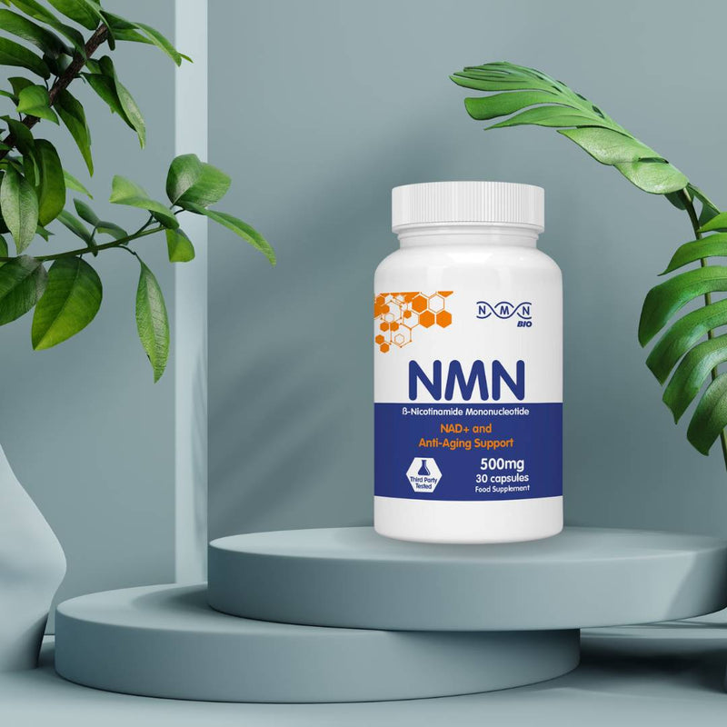 NMNBio NMN 500mg supplement bottle on minimalist display with plants, promoting NAD+ production, energy, and anti-aging support